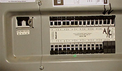 A breaker box with the AC breaker labeled