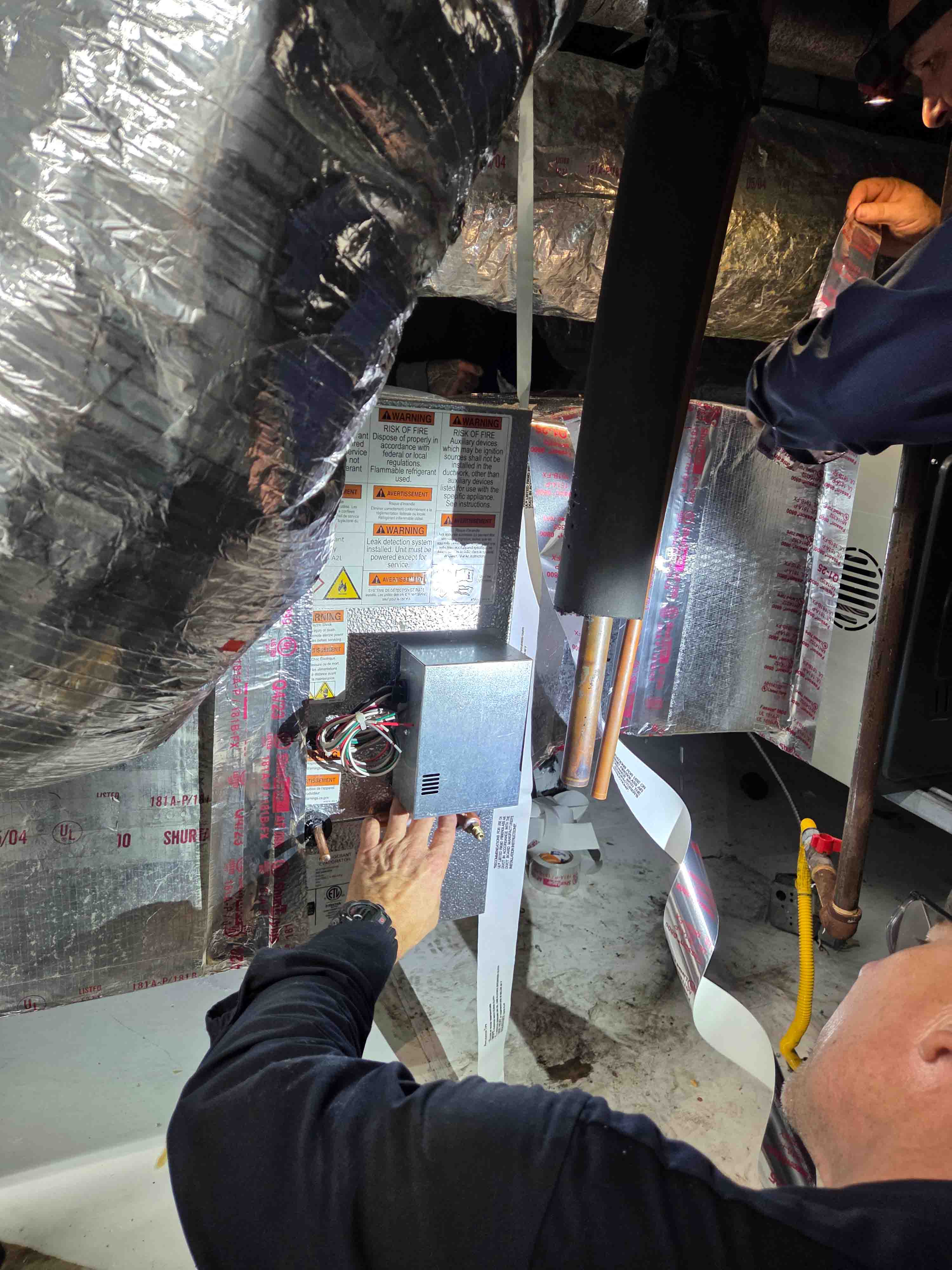 Adams Air HVAC technicians installing new HVAC equipment, representing Houston's trusted family-owned AC installation company