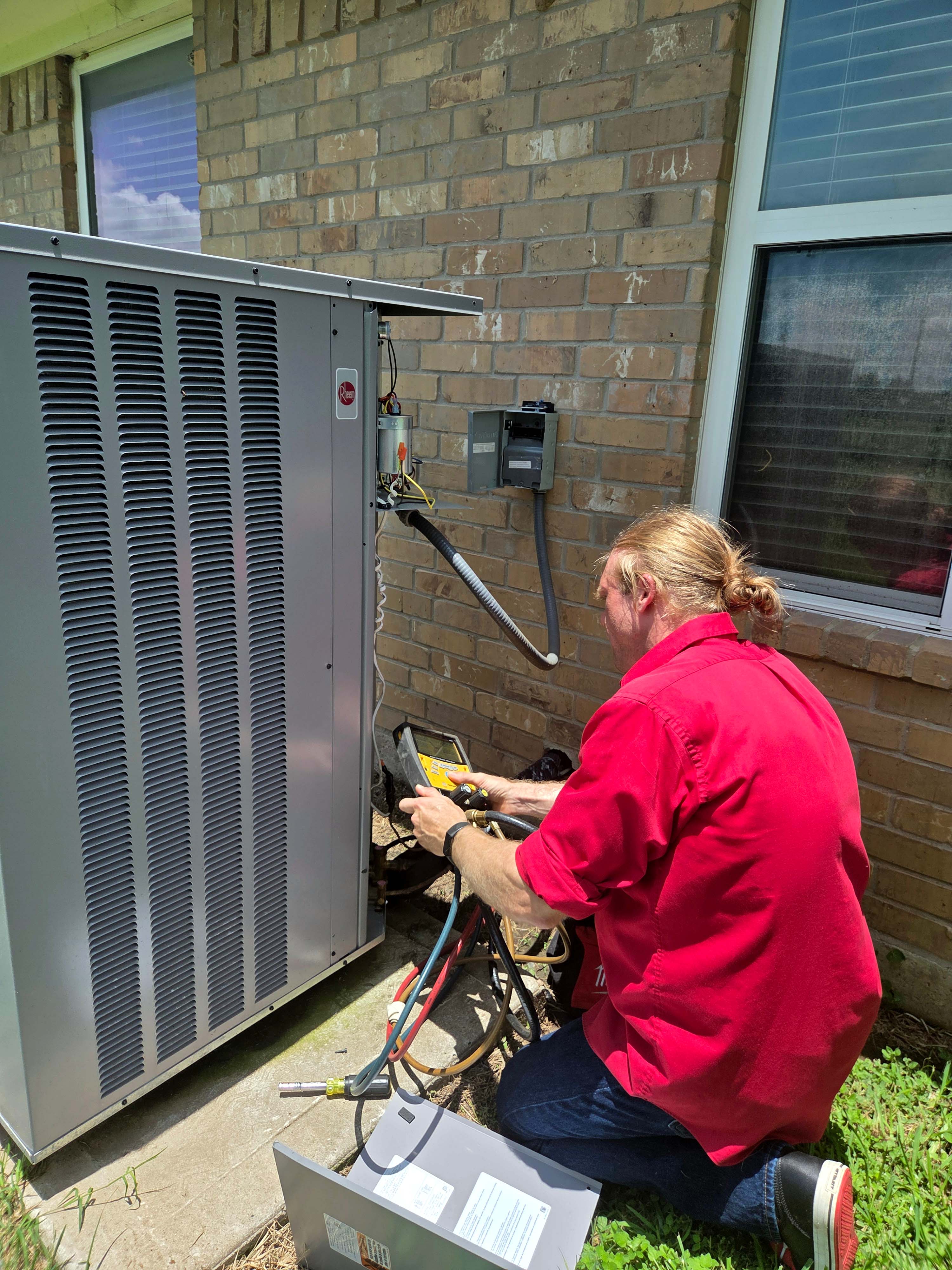 Professional Adams Air HVAC technician installing a new energy-efficient air conditioning unit in a Houston home