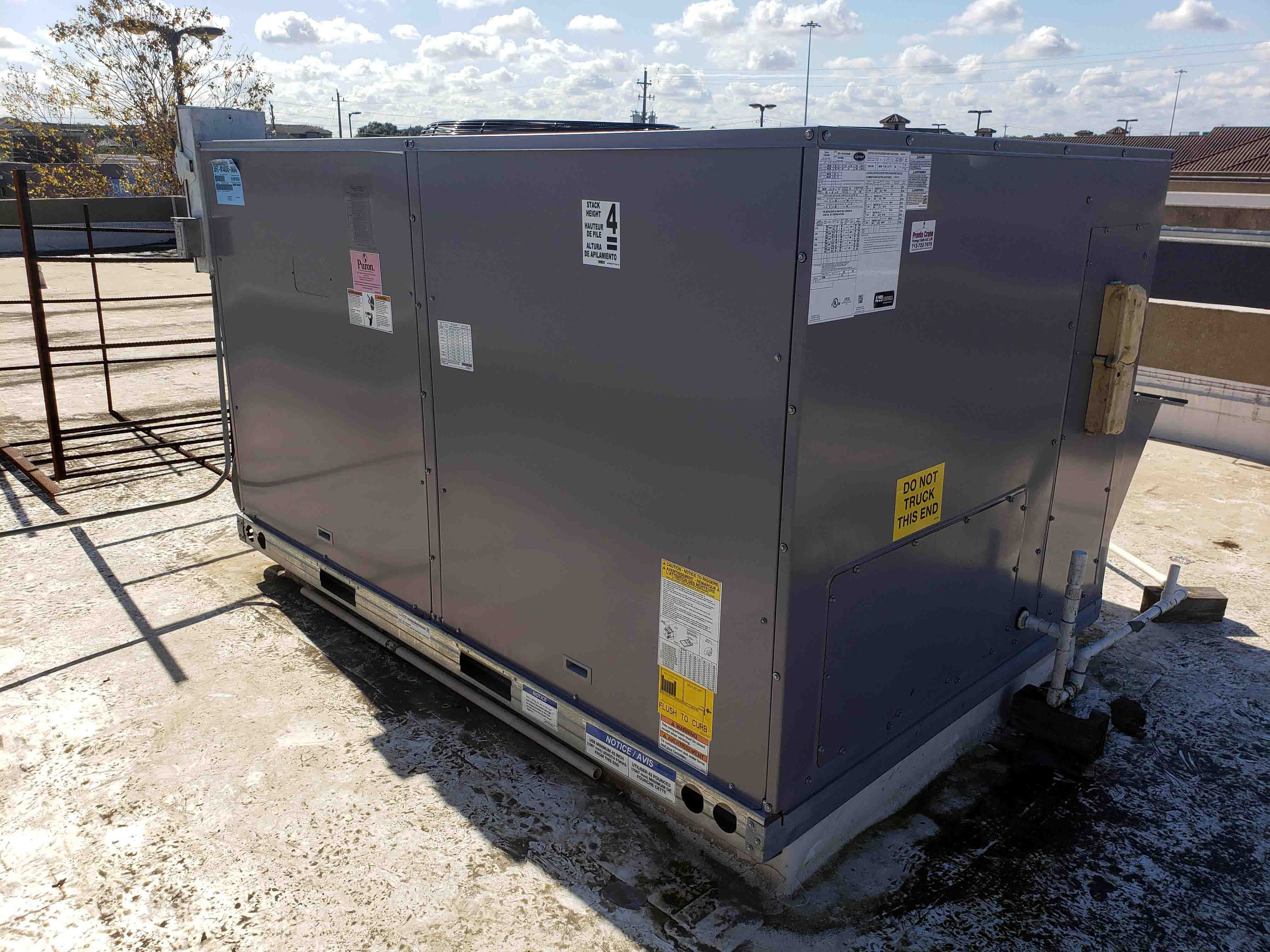 Rooftop Carrier brand packaged HVAC system professionally installed on commercial building by Adams Air