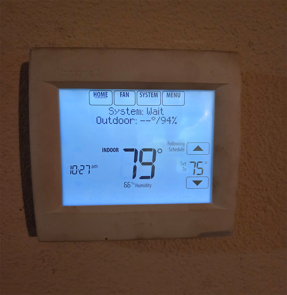 Digital thermostat displaying error message or delay, common AC problem in Houston homes