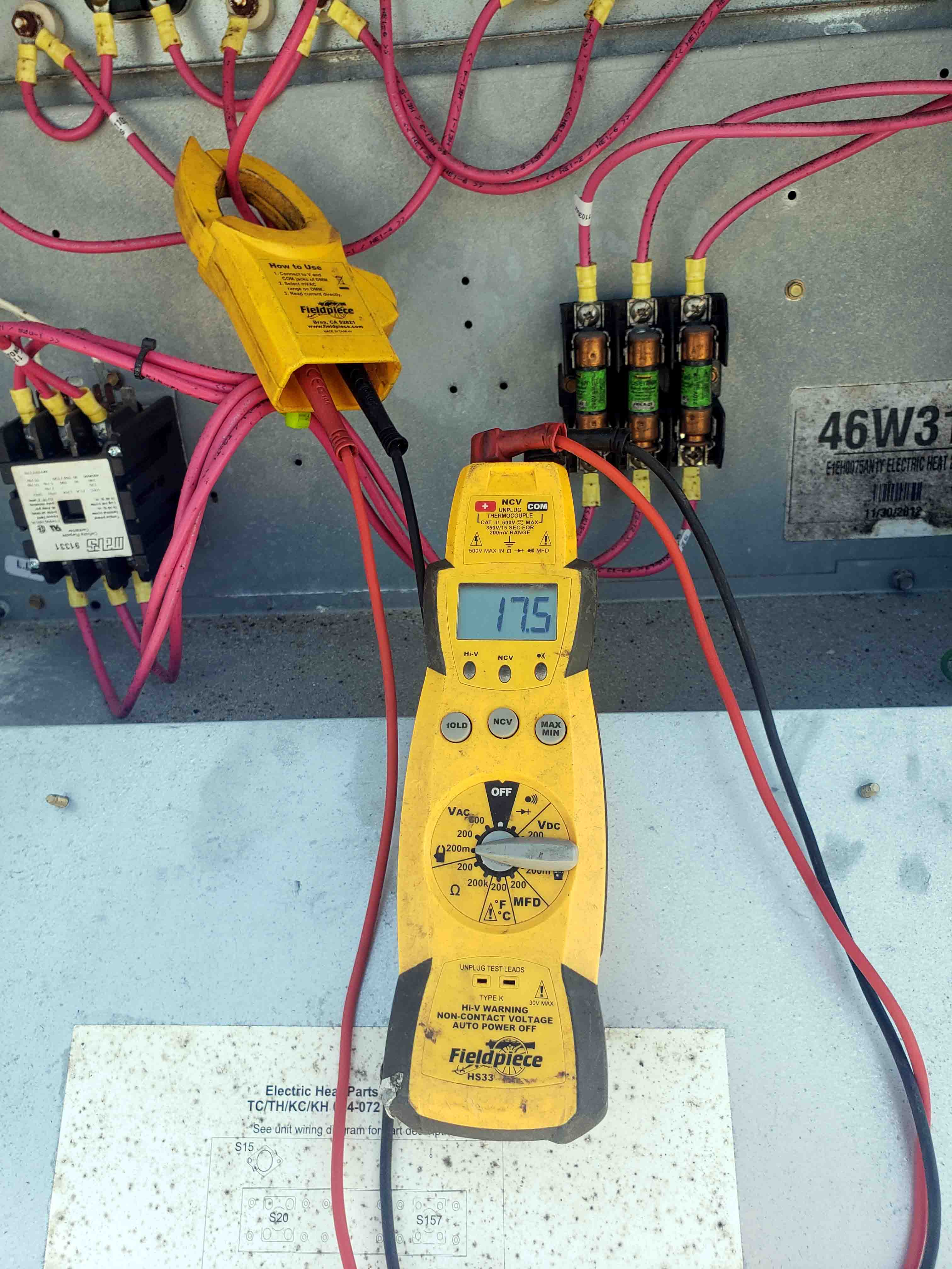 An electrical meter reading the amperage of a heater during professional AC system inspection and diagnostic testing