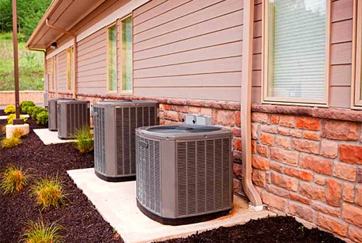 Professional AC installation Houston TX - 4 new American Standard condenser units installed outside commercial property by Adams Air
