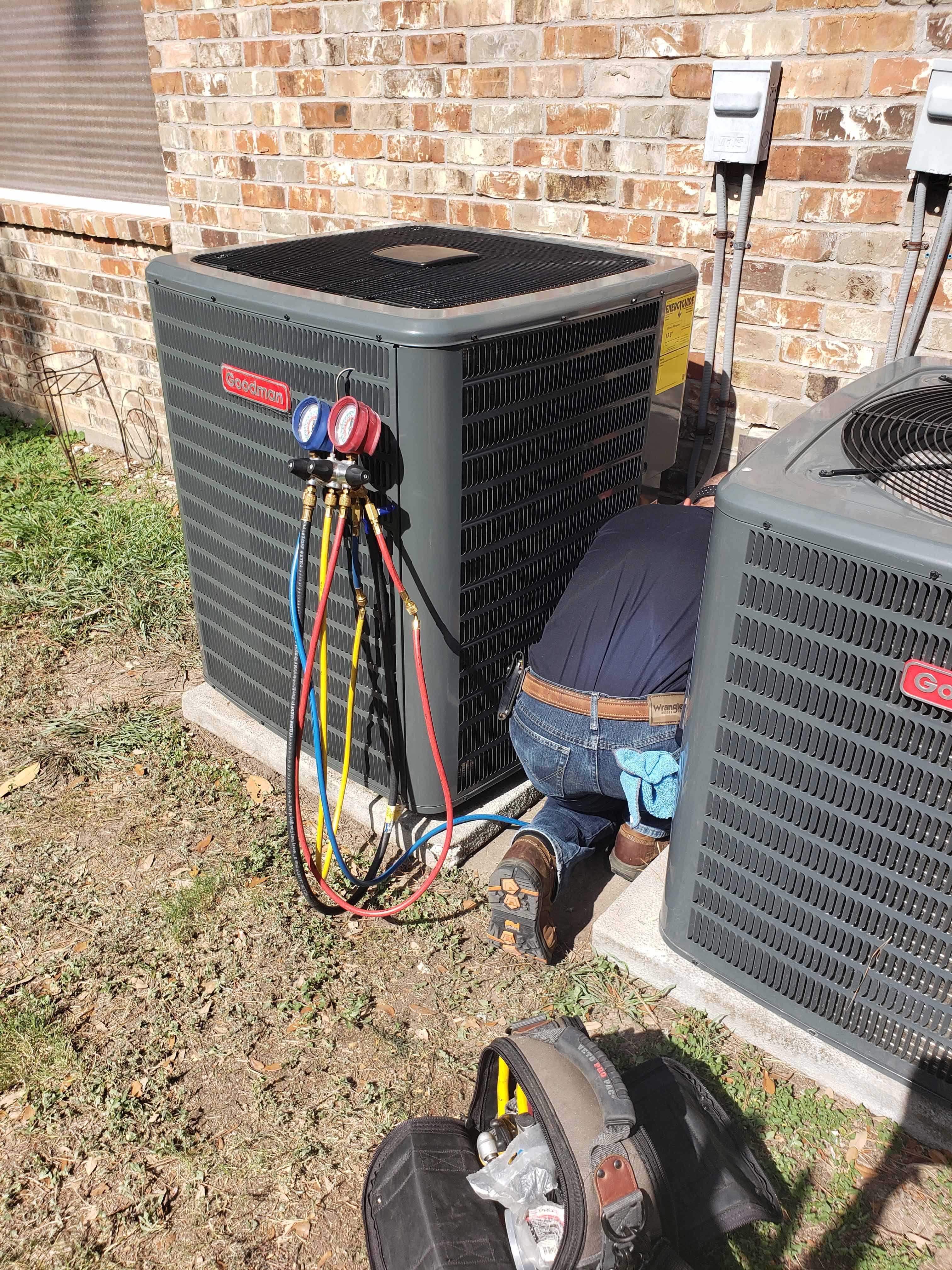 Professional AC installation Houston - New Goodman 5-ton condenser being installed outside residential home by Adams Air