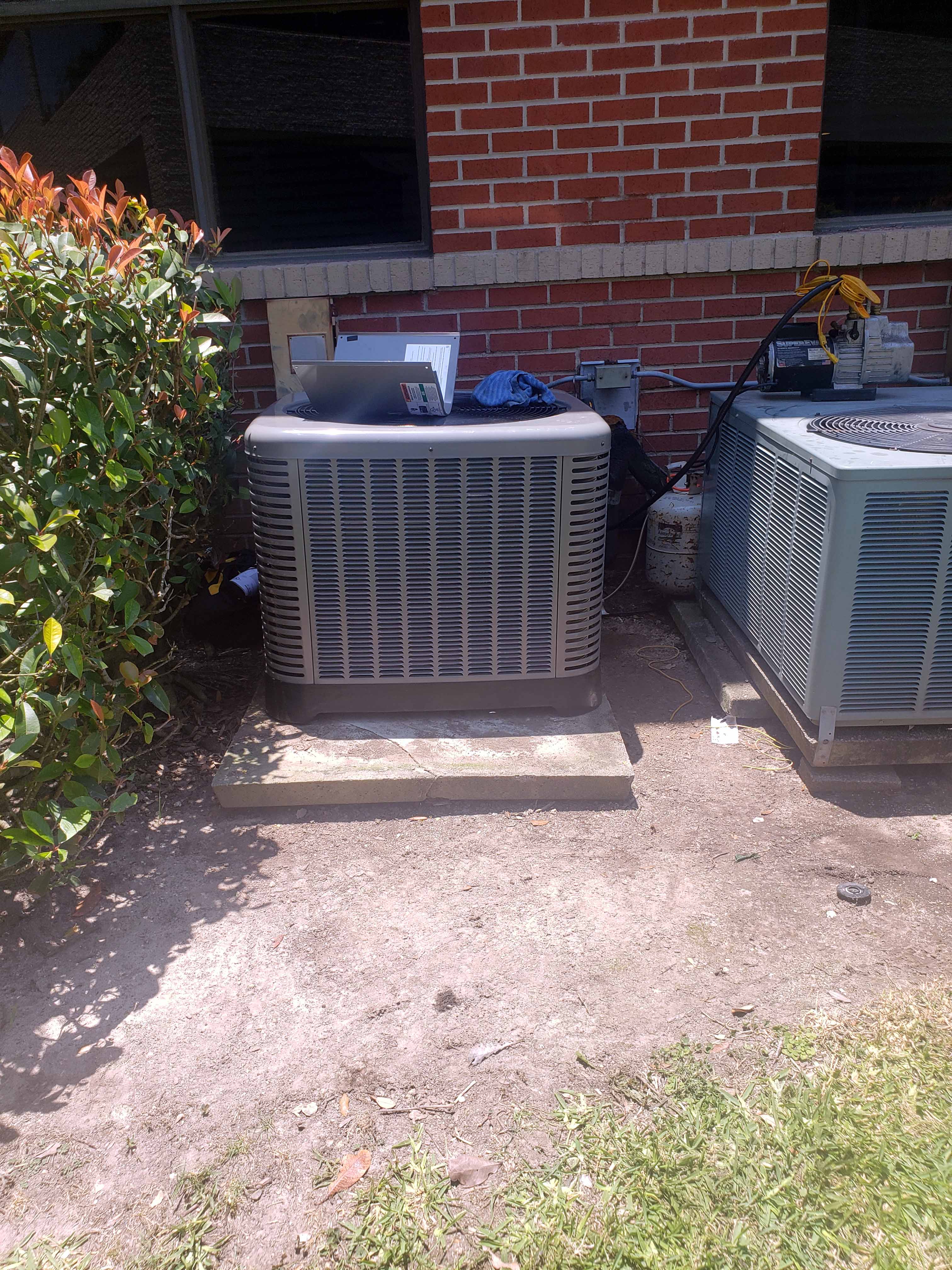 Professional AC installation Houston - Rheem condenser installation process documented by Adams Air team