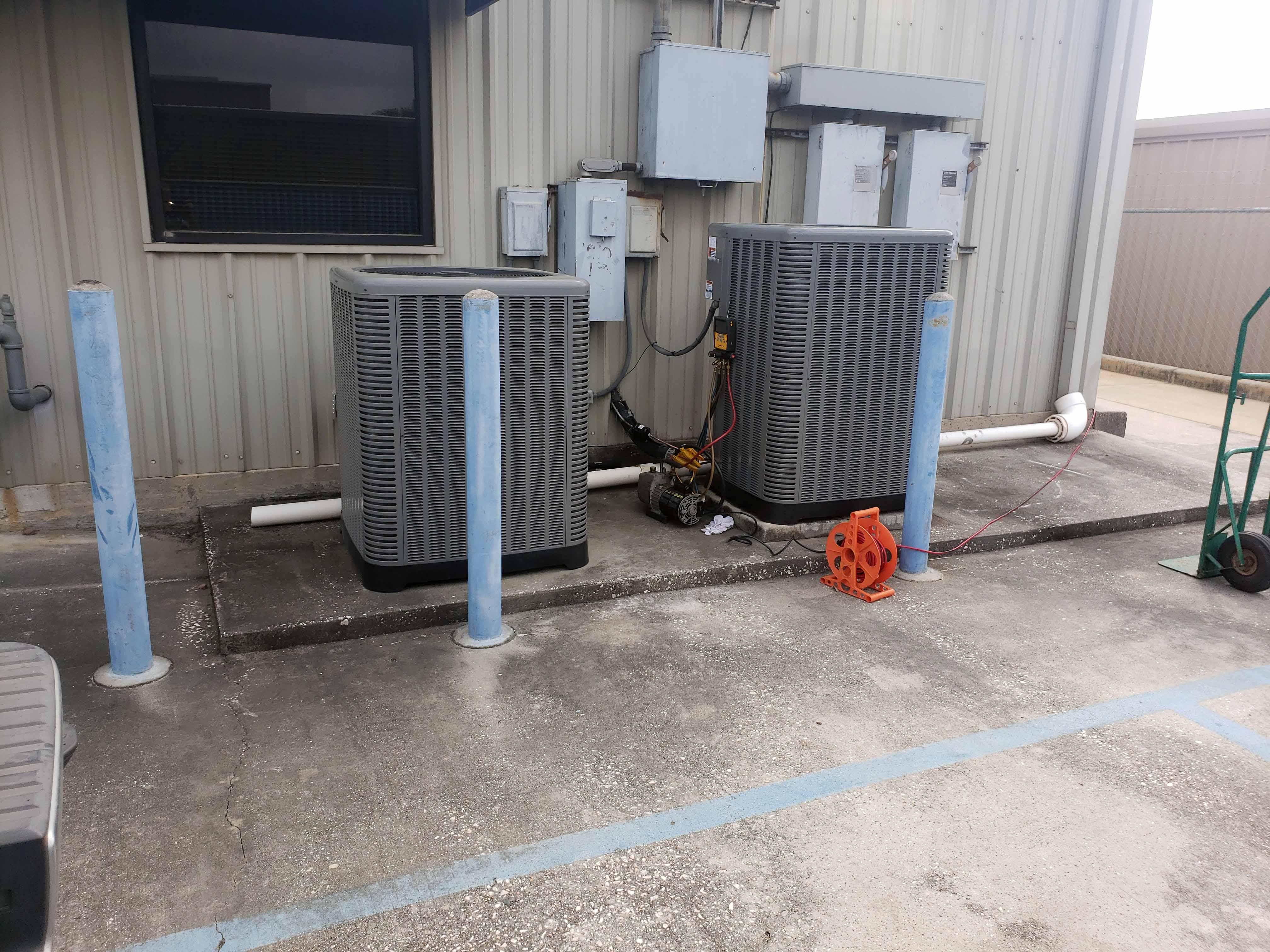 Professional AC installation Houston - 2 new Rheem condensers freshly installed side by side by Adams Air team