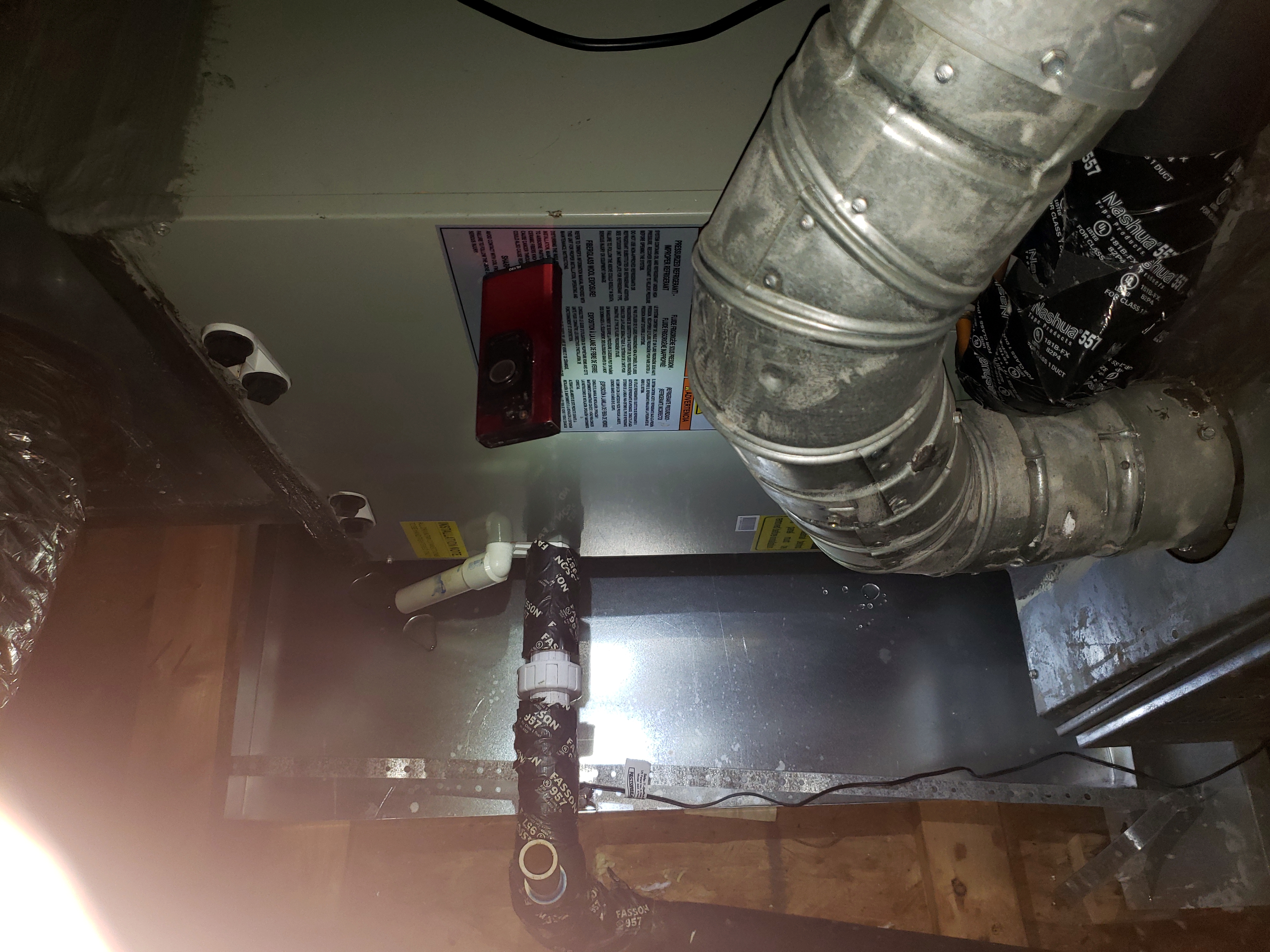 A residential gas furnace in a utility room showing home heating system installation and maintenance work